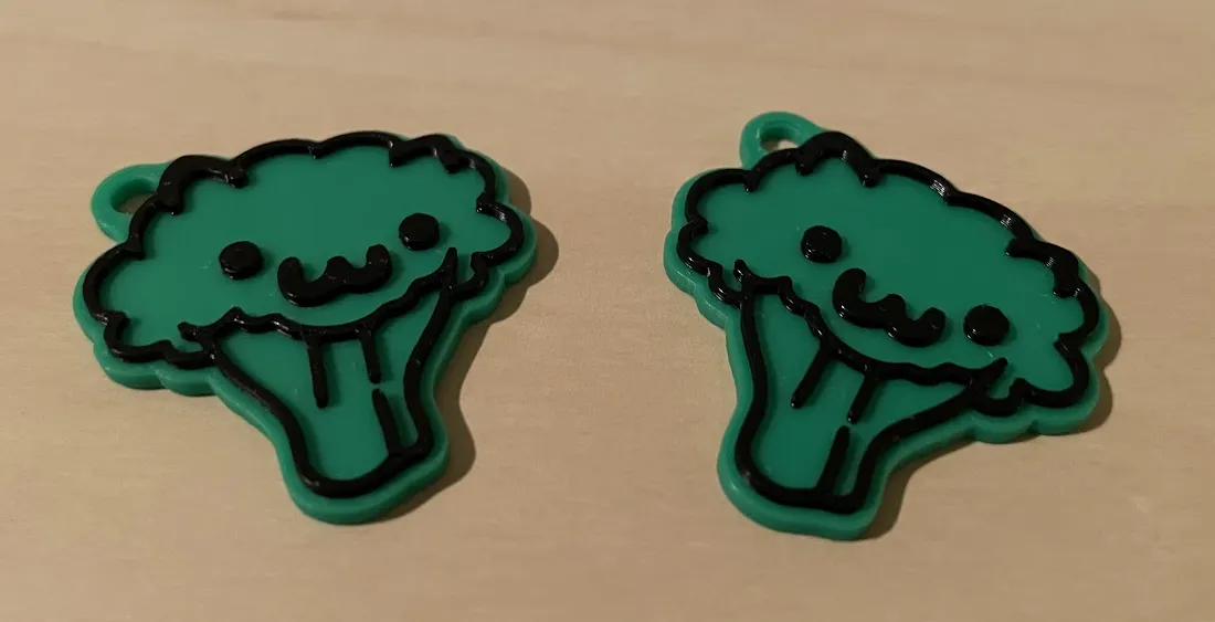 A green 3D-printed broccoli keychain